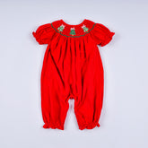Red baby romper with green embroidery on a white background