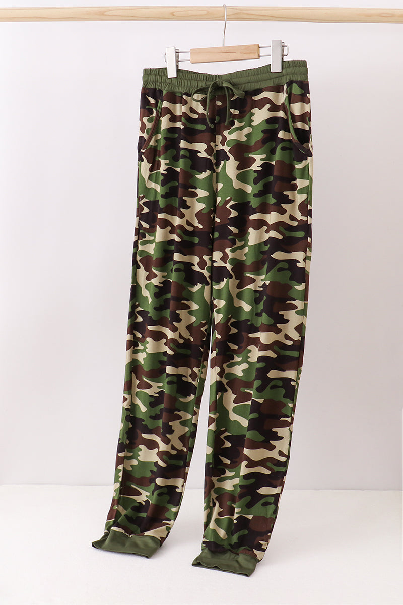 Camouflage pants on a hanger against a white background Aaria Tees