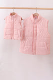 Two pink puffer vests hanging on a rack against a white background Aaria Tees