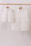 Two white puffer vests hanging on wooden hangers against a white background Aaria Tees