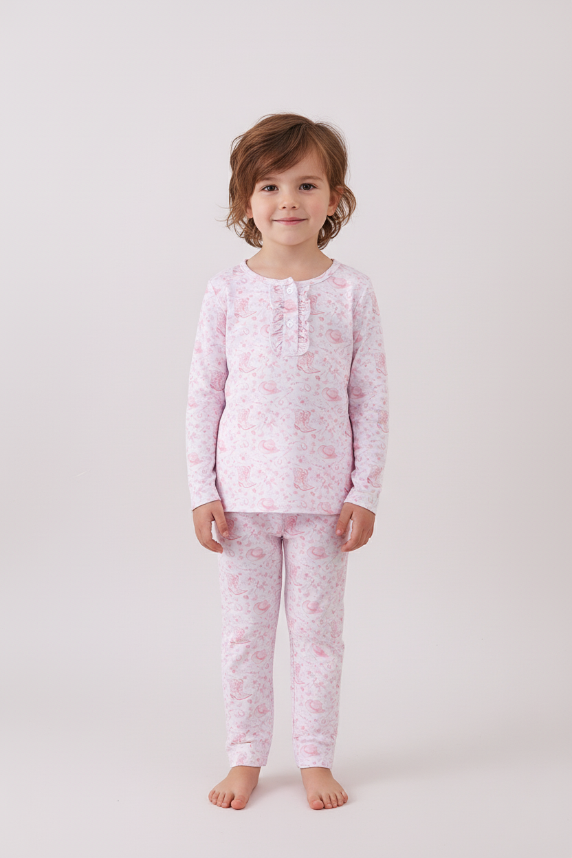Child wearing pink floral pajamas on a white background Aaria Tees
