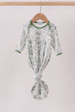 Green and white patterned baby outfit on a hanger against a light background Aaria Tees