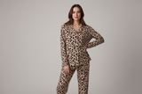 Woman wearing leopard print pajamas on a gray background Aaria Tees